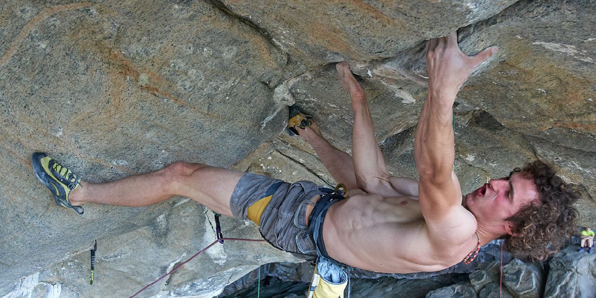 Adam Ondra climbing upside down on the steep cave route Silence in Norway