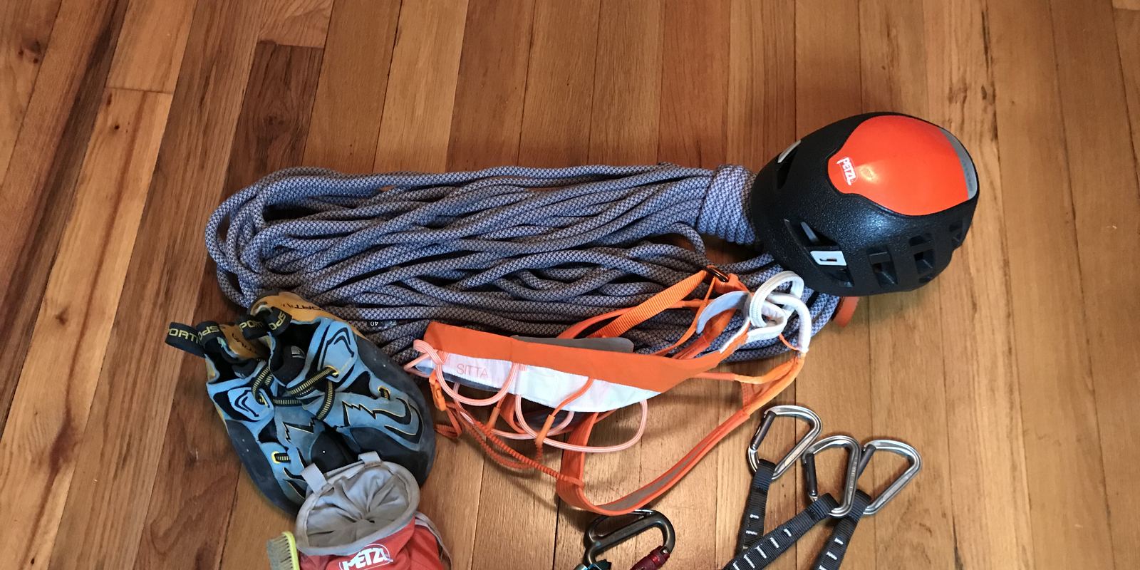 Climbing harnesses, quickdraws and carabiners laid out