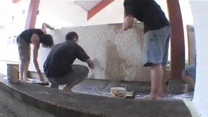 Parkour practitioners repainting a wall in Lisses